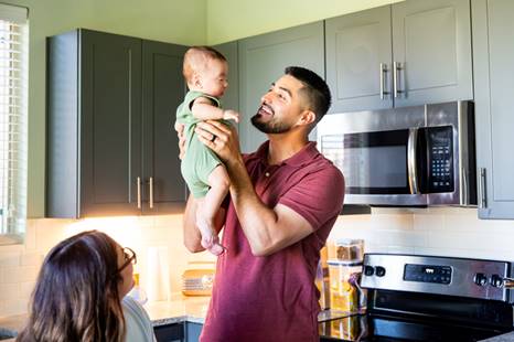 Man holding baby up - FMLA Retaliation